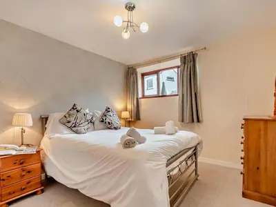 a bedroom with a large white bed and a window at 2 Bed in Keswick oc-28383 in Braithwaite