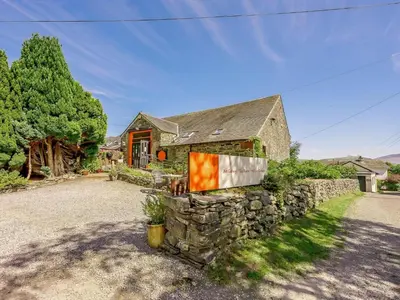 a stone house with a stone wall at 2 Bed in Keswick 28377 in Braithwaite