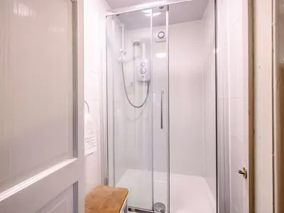 a shower with a glass door in a bathroom at 1 Bed in Keswick oc-28382 in Braithwaite