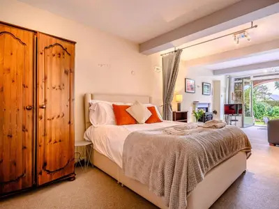 a bedroom with a bed and a wooden cabinet at 1 Bed in Keswick oc-28382 in Braithwaite
