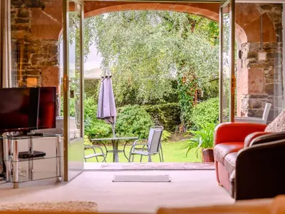 a living room with a door open to a patio at 1 Bed in Keswick oc-28382 in Braithwaite