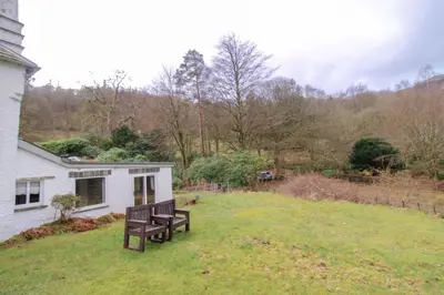 a bench sitting in the yard of a house at Grasmere View, stunning views over Grasmere Lake, ideal romantic break in Grasmere