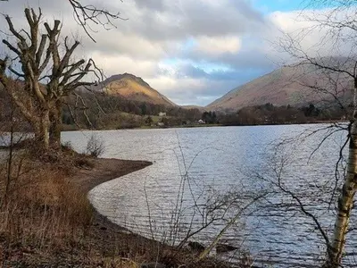 a body of water with mountains in the background at Grasmere View, stunning views over Grasmere Lake, ideal romantic break in Grasmere