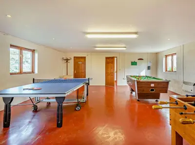 a room with a ping pong table and a pool table at 2 Bed in Bassenthwaite 93463 in Ireby
