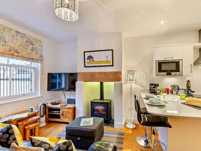 a living room with a fireplace and a stove in it at 1 Bed in Keswick 93386 in Keswick