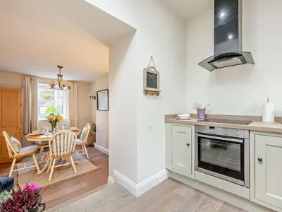 a kitchen and dining room with a table and chairs at 2 Bed in Bridekirk 93280 in Bridekirk