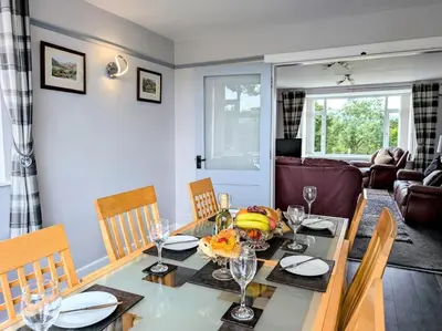 a dining room with a table and chairs at 3 Bed in Keswick 93202 in Keswick