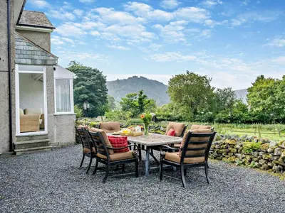 a patio with a table and chairs with a view at 3 Bed in Keswick 93202 in Keswick