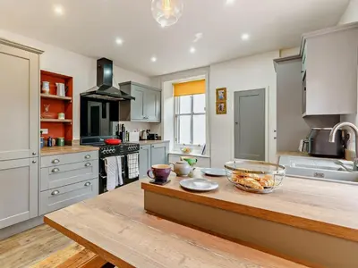 a kitchen with a counter with a bowl of fruit on it at 1 Bed in Cockermouth oc-93147 in Cockermouth