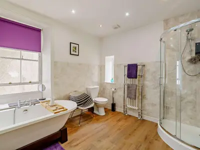 a bathroom with a tub and a shower and a toilet at 1 Bed in Cockermouth oc-93147 in Cockermouth