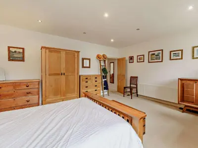 a large bedroom with a bed and a dresser at 1 Bed in Cockermouth oc-93147 in Cockermouth