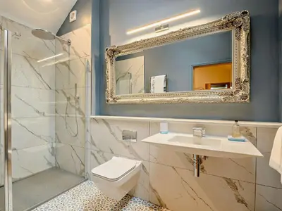 a bathroom with a toilet and a sink and a mirror at 1 Bed in Lockerbie 93110 in Lockerbie