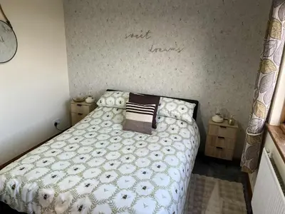a bedroom with a bed and two night stands at 3 Bed in Mochrum 87541 in Mochrum