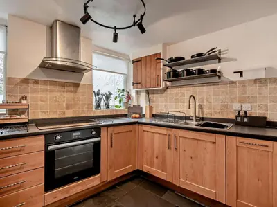 a kitchen with wooden cabinets and a sink at 2 Bed in Ambleside oc-sz500 in Grasmere