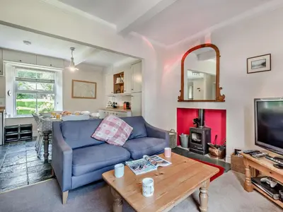 a living room with a blue couch and a table at 3 Bed in Chapel Stile SZ161 in Chapel Stile