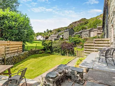 a patio with a fire pit in a yard at 3 Bed in Chapel Stile SZ161 in Chapel Stile