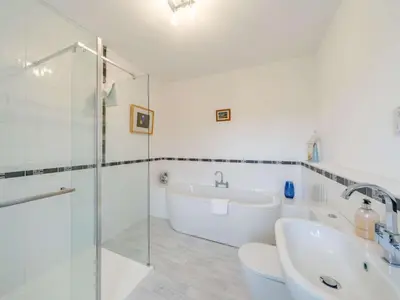 a bathroom with a tub and a sink and a shower at 4 Bed in Cockermouth oc-85979 in Buttermere