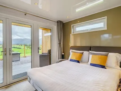a bedroom with a bed and a sliding glass door at 1 Bed in Keswick oc-82476 in Bassenthwaite