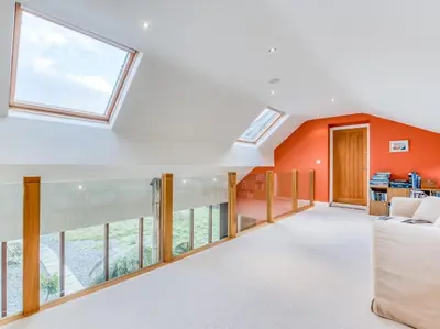 an open living room with orange walls and windows at 4 Bed in Broughton Mills 75286 in Seathwaite