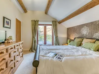 a bedroom with a large bed and a tv at 4 Bed in Broughton Mills 75286 in Seathwaite
