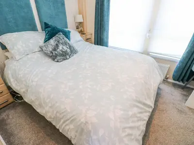 a bed with two pillows on it in a bedroom at A and C Lodge-Plot 21 in Carlisle