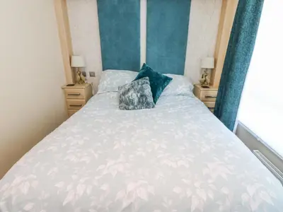 a bed with two pillows on it in a bedroom at A and C Lodge-Plot 21 in Carlisle