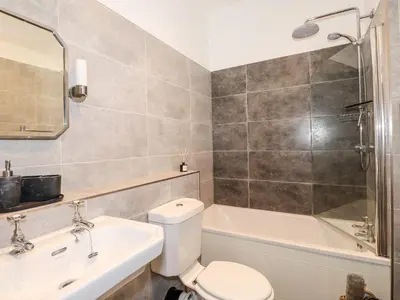 a bathroom with a toilet and a tub and a sink at Walla Crag, Royal Oak House in Keswick