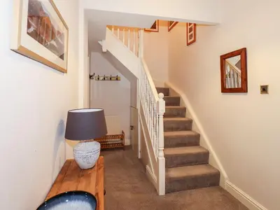 a staircase in a house with a table and a lamp at Walla Crag, Royal Oak House in Keswick