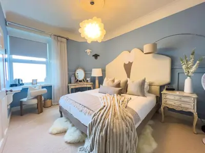 a bedroom with a large bed and a window at Abbotsford Hotel in Ayr