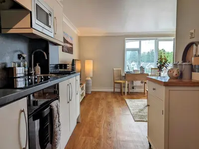 a kitchen with white cabinets and a counter top at 1 Bed in Keswick SZ468 in Keswick
