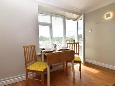 a dining room with a table and chairs and a window at 1 Bed in Keswick SZ468 in Keswick