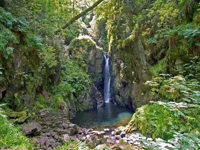 a waterfall in a canyon with a pool of water at 4 Bed in Holmrook oc-sz158 in Eskdale