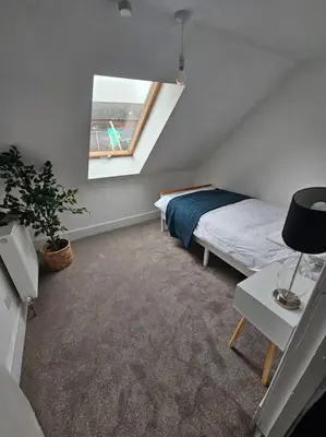 a bedroom with a bed and a window at HollyJess Hoose in Stranraer