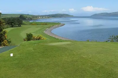 a golf course with a view of the water at HollyJess Hoose in Stranraer