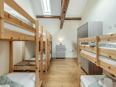 a room with several bunk beds in a room at Herdwick House - Uk42805 in Mungrisdale