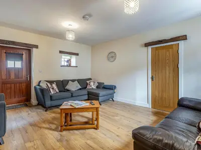 a living room with a couch and a table at Herdwick House - Uk42805 in Mungrisdale