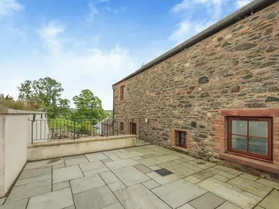 an outdoor patio with a brick building at Herdwick House - Uk42805 in Mungrisdale