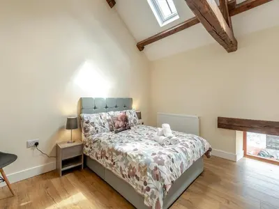 a bedroom with a bed with a teddy bear on it at Herdwick House - Uk42805 in Mungrisdale