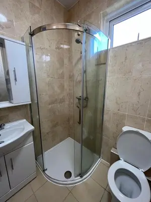 a bathroom with a shower and a toilet at Luxury 1BR Flat Central Dumfries Self Check-in, Parking, Wi-Fi in Dumfries