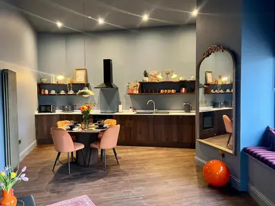 a kitchen with a table and chairs and a counter at The Bank - Rooms & Apartments by Coorie Doon Stays in Troon
