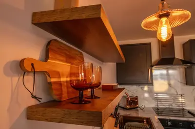a wine glass sitting on a counter in a kitchen at The Bradan - Troon - Coorie Doon Stays in Troon