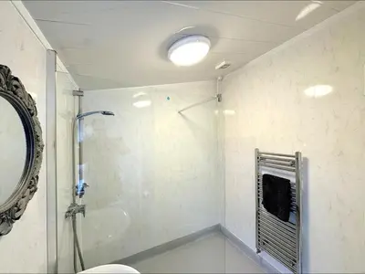 a bathroom with a shower and a mirror at Ameliafield Cottage, Prestwick in Prestwick