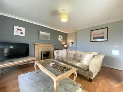 a living room with a couch and a coffee table at 17 The Park in Onchan
