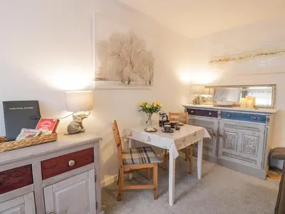 a small kitchen with a table and a table and a table and a tableablish at Rosalin Cottage in Irvine