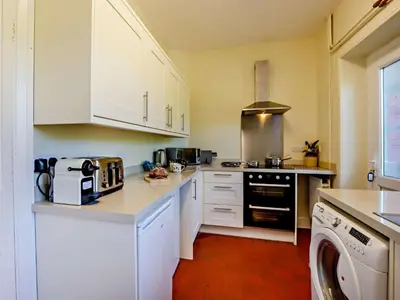 a kitchen with white cabinets and a dishwasher at 2 Bed in Holmrook oc-sz403 in Santon Bridge