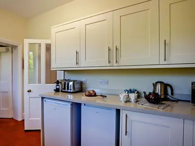 a kitchen with white cabinets and a counter top at 2 Bed in Holmrook oc-sz403 in Santon Bridge