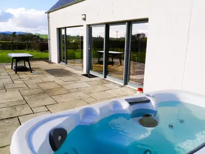 a large blue tub sitting outside of a house at The Longhouse in Castle Douglas