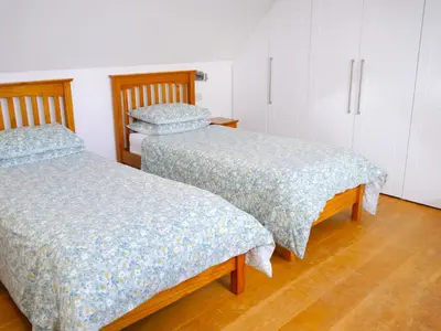 two beds sitting next to each other in a room at The Longhouse in Castle Douglas