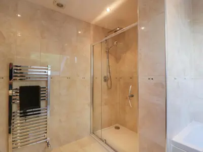 a shower with a glass door in a bathroom at Merse End in Dalbeattie