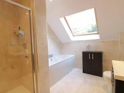 a bathroom with a shower and a bath tub at Merse End in Dalbeattie